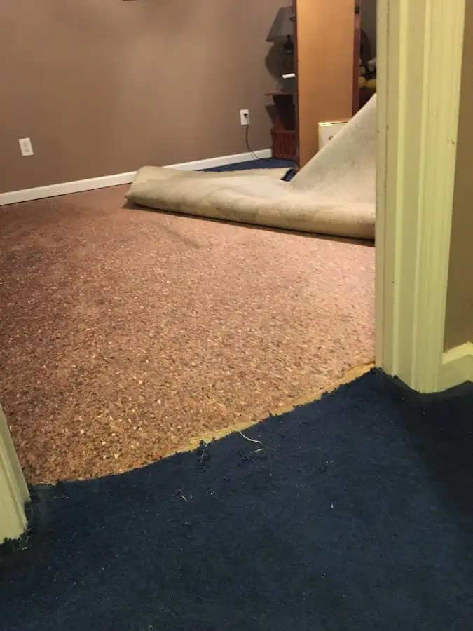 Carpet pad removal revealing water damage during Water Mitigation Services in Elk City